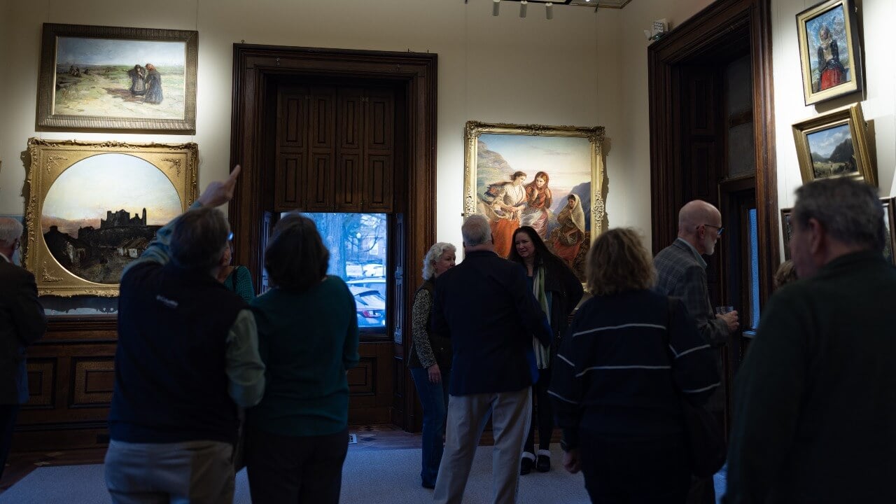 Community members looking at the exhibition of the Ireland Great Hunger Museum