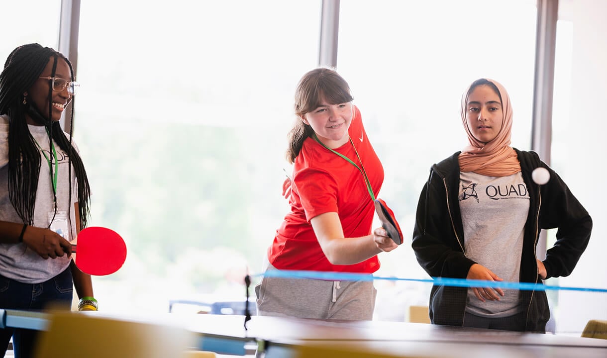 Students play ping-pong.