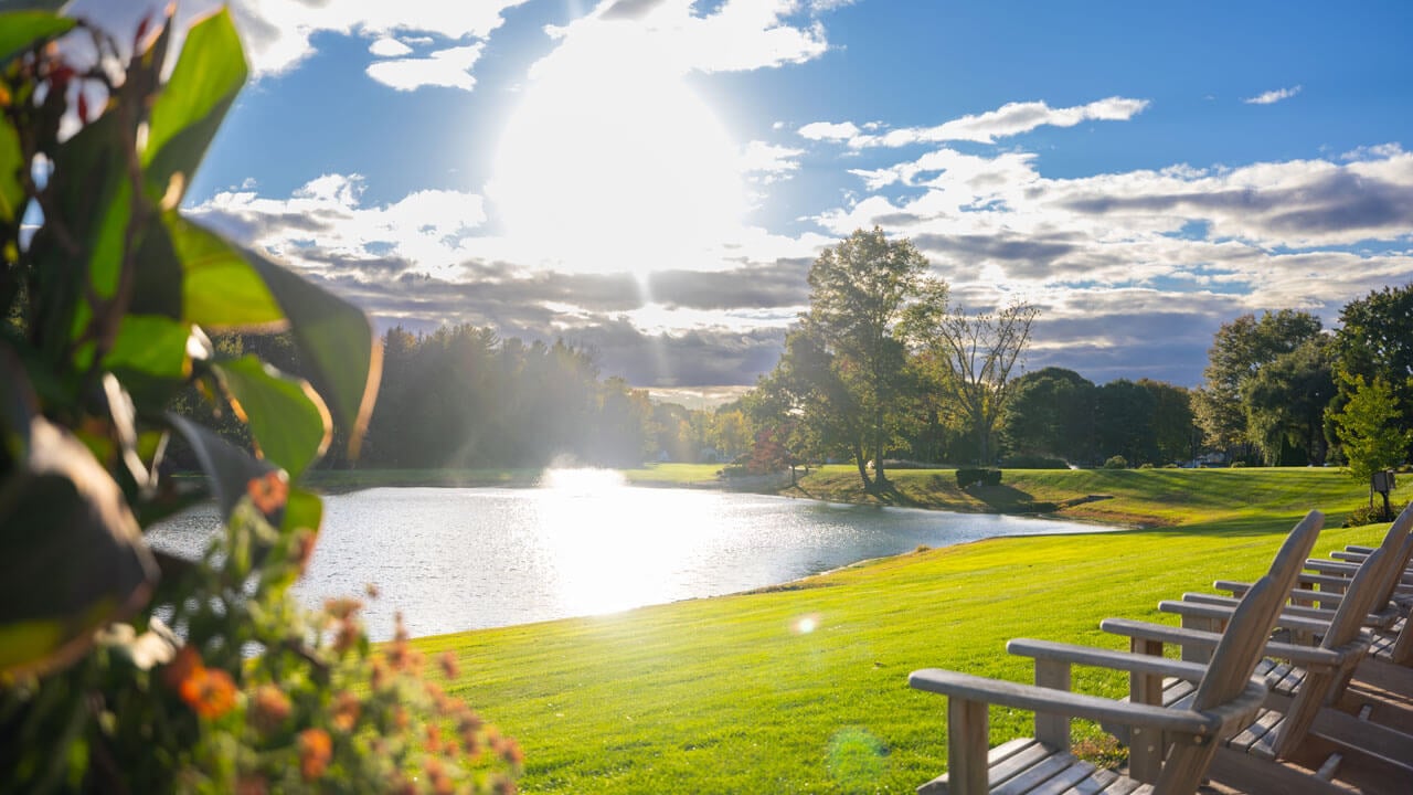 Beautiful sunny view of North Haven pond with benches facing the sun