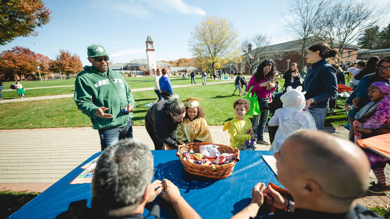 a family grouping engaging with a table and taking candy