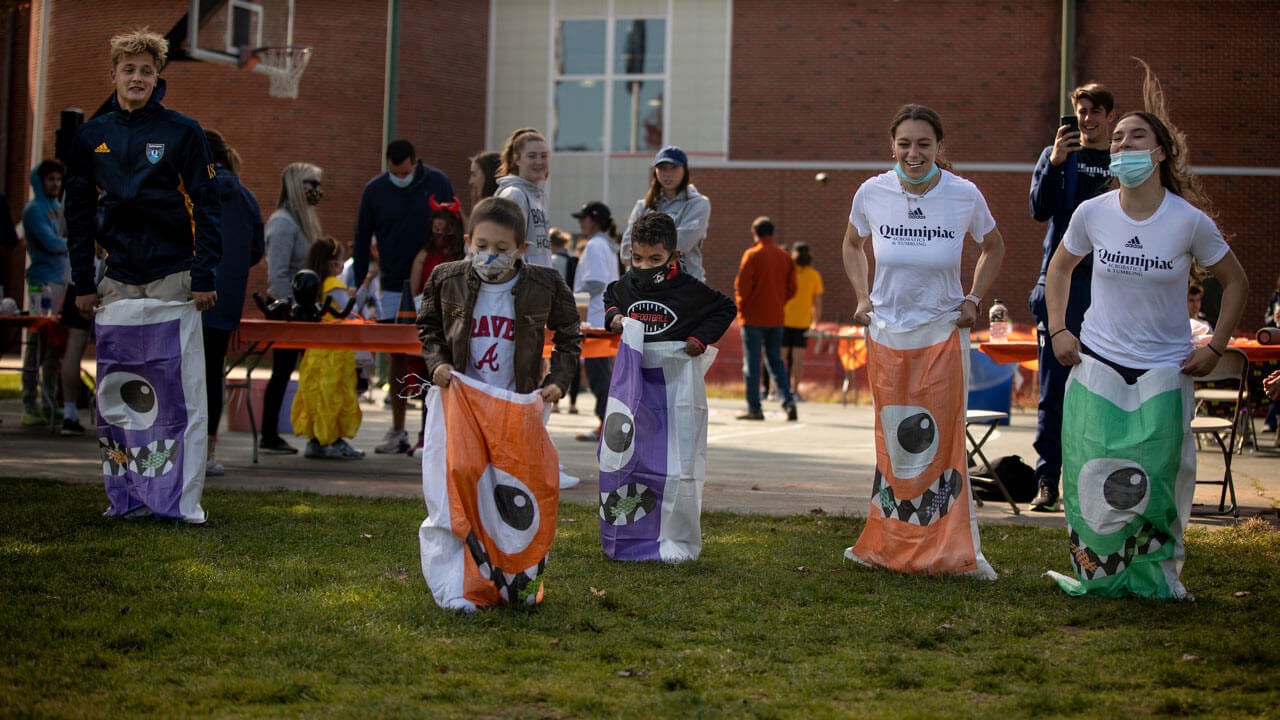 Quinnipiac students and community participate in potato sack race