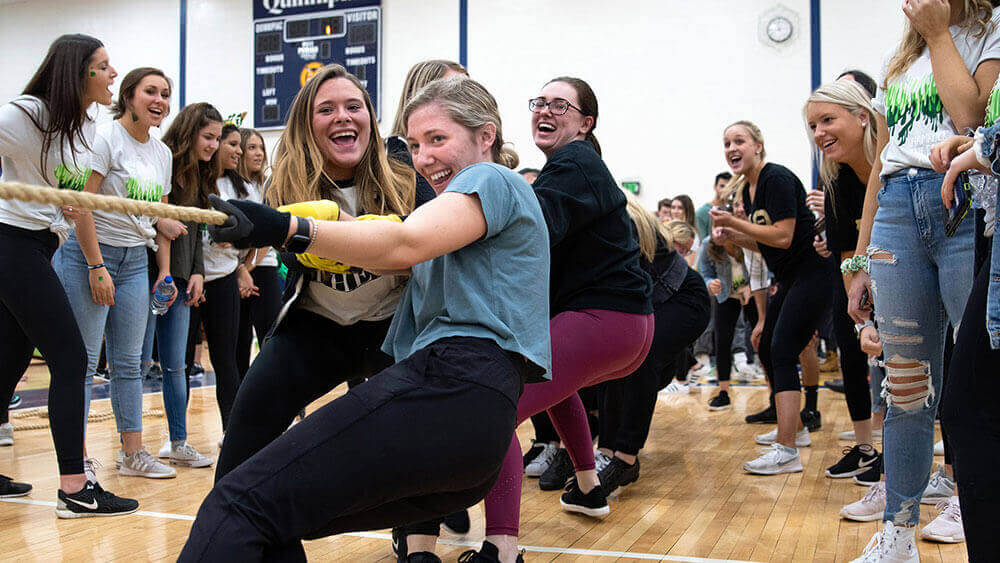Students compete in a game of tug-of-war for a charity fundraiser